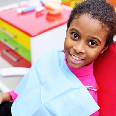 A young girl smiling in the dentist chair