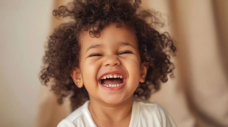 small child smiling with baby teeth