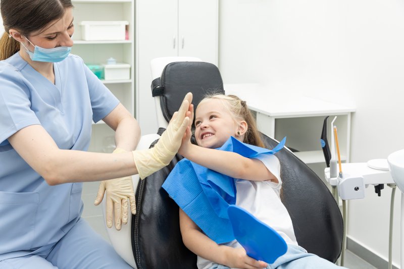 little girl smiling during visit with pediatric dentist