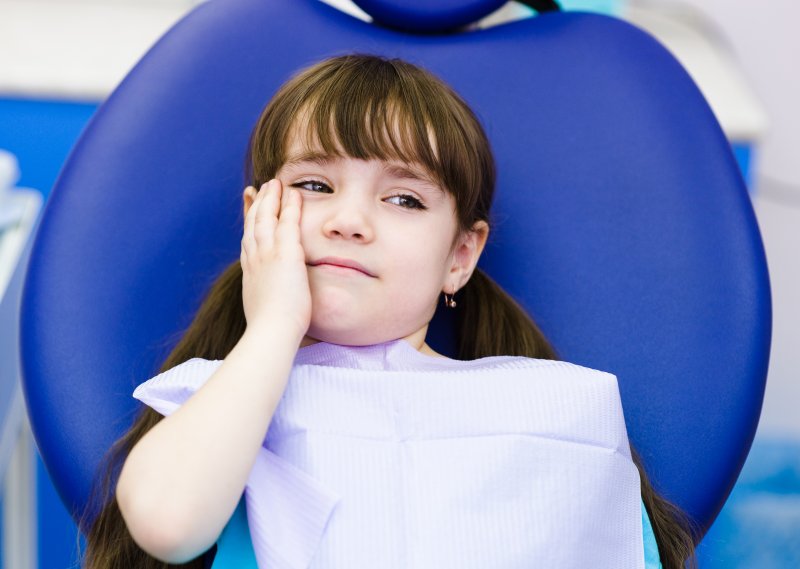 Child with a toothache at the dentist