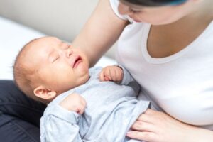 Mother trying to comfort her fussy baby