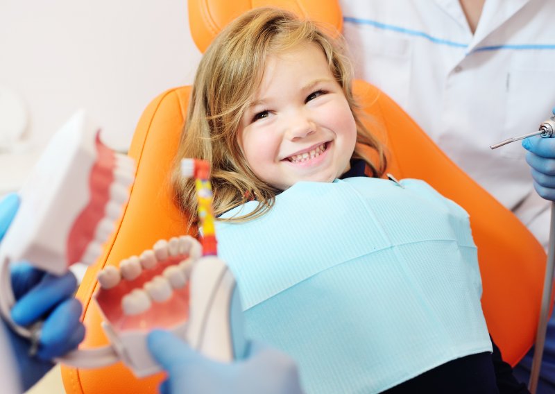 A little girl receiving treatment from her pediatric dentist